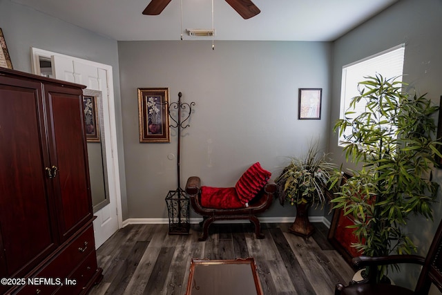 sitting room with dark hardwood / wood-style floors and ceiling fan