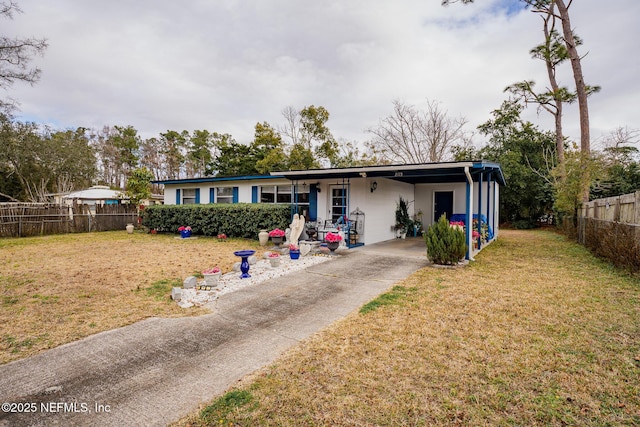 single story home featuring a carport and a front lawn