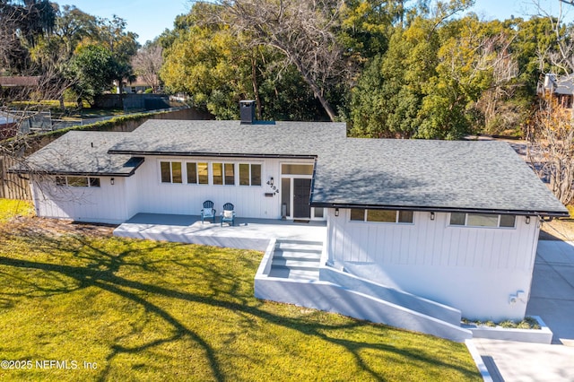 rear view of house featuring a yard and a patio area