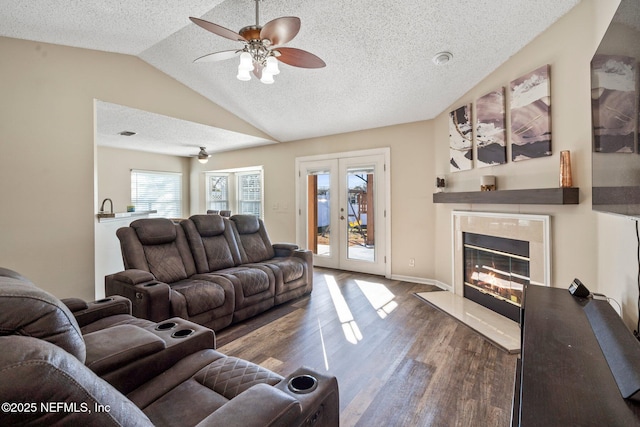 living room featuring french doors, lofted ceiling, a textured ceiling, dark hardwood / wood-style flooring, and a fireplace