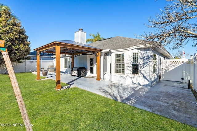 back of house with a gazebo, a lawn, and a patio