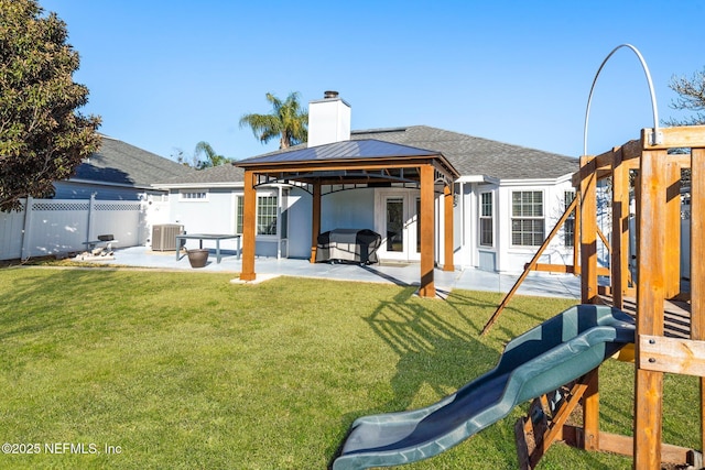 back of property featuring central AC, a gazebo, a lawn, a playground, and a patio