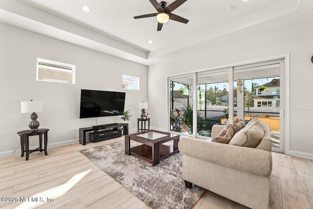 living room with light hardwood / wood-style floors and ceiling fan