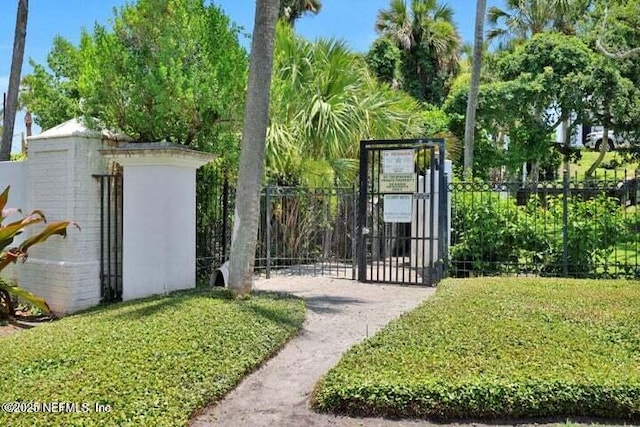 view of gate featuring a lawn