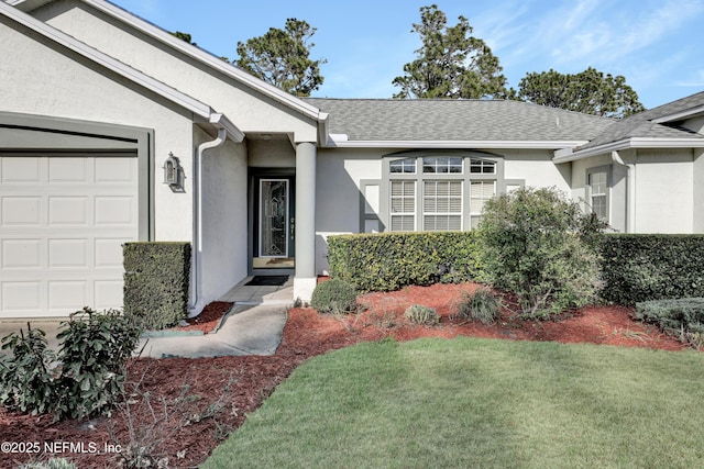 property entrance featuring a garage and a yard