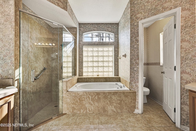 full bathroom with tile patterned floors, toilet, a textured ceiling, vanity, and independent shower and bath