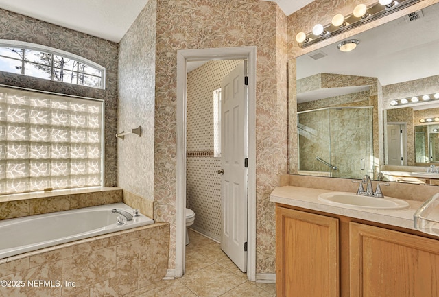 full bathroom with vanity, tile patterned floors, shower with separate bathtub, and toilet