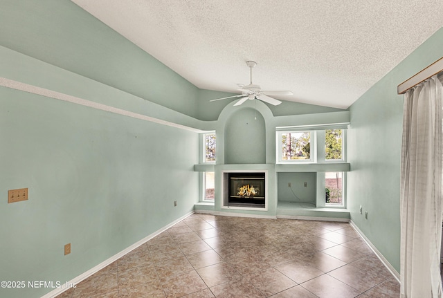 unfurnished living room with light tile patterned flooring, lofted ceiling, a textured ceiling, and ceiling fan