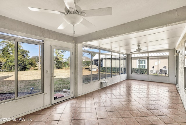 unfurnished sunroom featuring a wall mounted air conditioner and ceiling fan