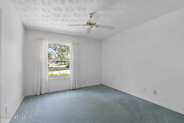 unfurnished room with carpet flooring, a ceiling fan, a textured ceiling, and baseboards
