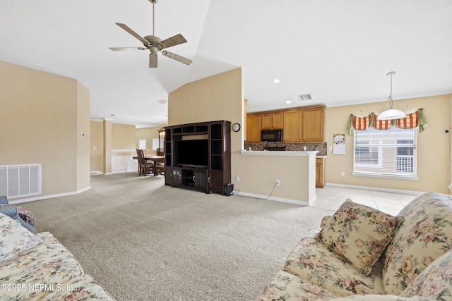 carpeted living room featuring vaulted ceiling and ceiling fan