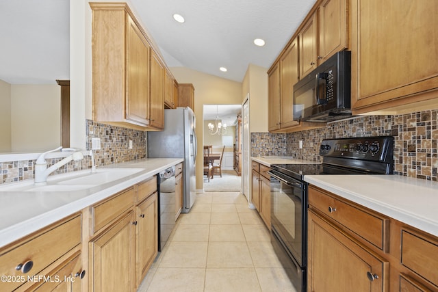 kitchen featuring tasteful backsplash, lofted ceiling, sink, light tile patterned floors, and black appliances