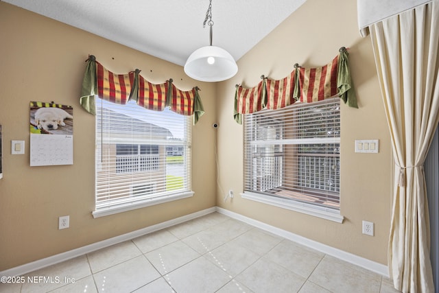 tiled empty room with a textured ceiling