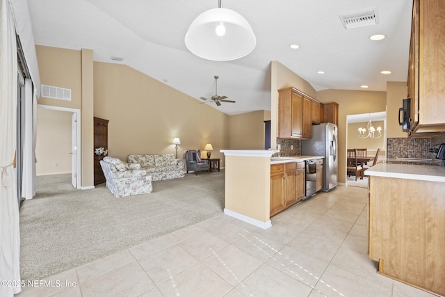 kitchen featuring light carpet, ceiling fan with notable chandelier, black appliances, and lofted ceiling