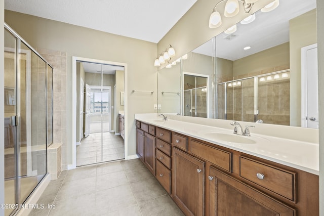 bathroom with tile patterned flooring, vanity, and a shower with shower door