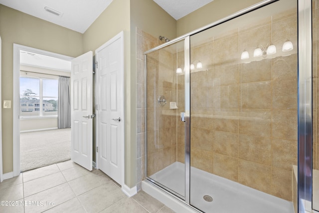 bathroom featuring tile patterned floors and an enclosed shower