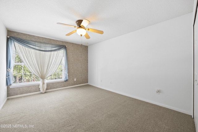 spare room with carpet floors and ceiling fan