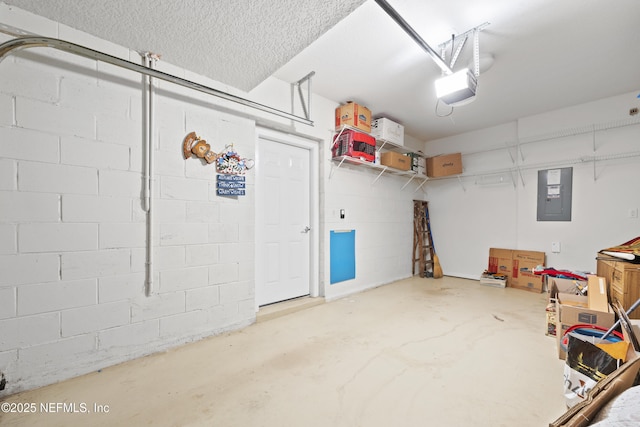 garage with a garage door opener and electric panel