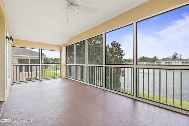 unfurnished sunroom with vaulted ceiling, ceiling fan, and a water view