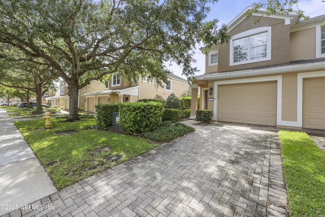 view of front of home with a garage and a front yard