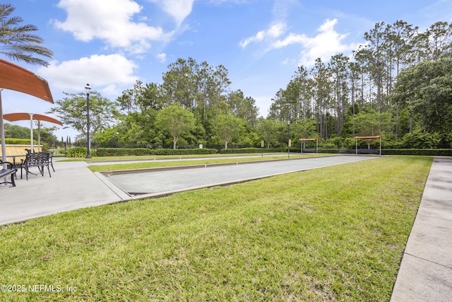 view of home's community with a yard