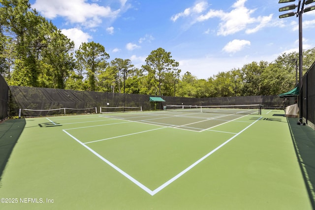 view of tennis court with basketball hoop