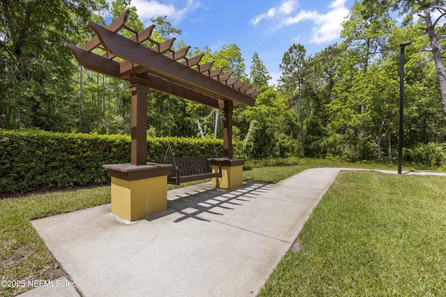 surrounding community featuring a pergola, a patio area, and a lawn