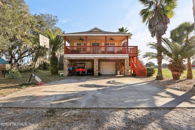 view of front facade with a garage, covered porch, and ceiling fan