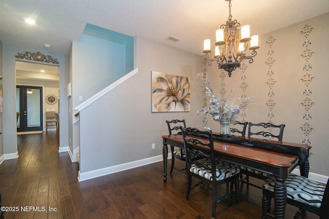 dining area with a notable chandelier and dark wood-type flooring