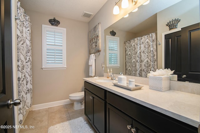 bathroom featuring tile patterned floors, toilet, and vanity