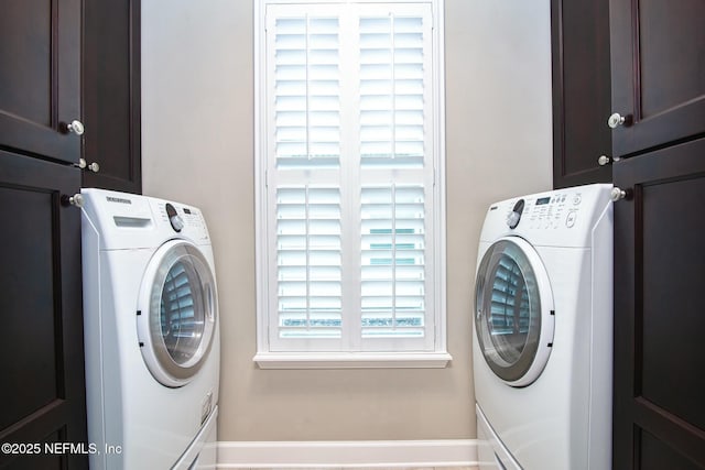 clothes washing area with independent washer and dryer and cabinets