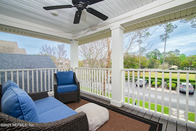 deck with ceiling fan and covered porch