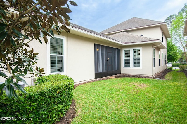 rear view of property featuring a lawn