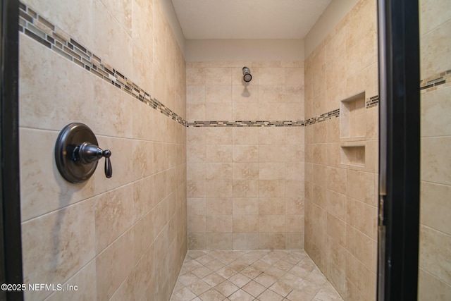 bathroom with tiled shower