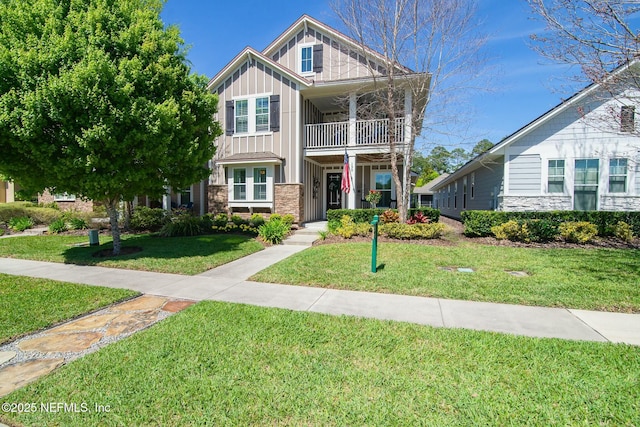 view of front of property with a balcony and a front lawn