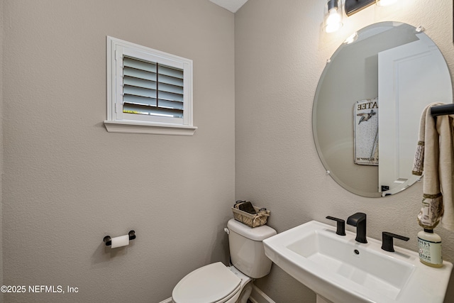 bathroom featuring sink and toilet