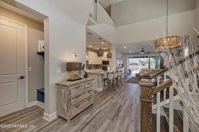 interior space with hardwood / wood-style flooring and a high ceiling