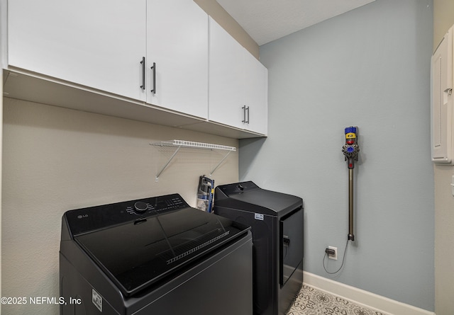 laundry area featuring cabinets and washer and clothes dryer