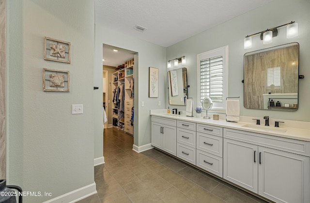 bathroom with vanity, tile patterned floors, and a textured ceiling