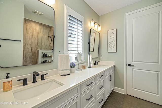 bathroom with vanity, tile patterned floors, and a textured ceiling