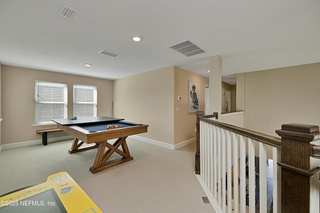 playroom with light carpet, billiards, and a textured ceiling