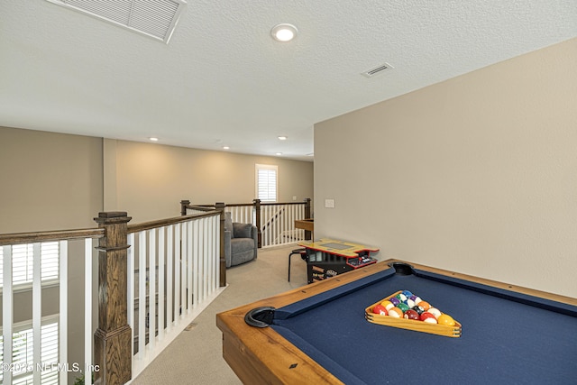 playroom featuring billiards, light colored carpet, and a textured ceiling