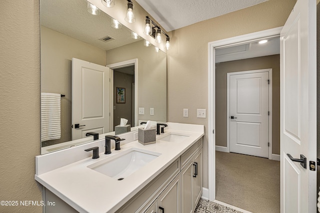 bathroom with vanity and a textured ceiling