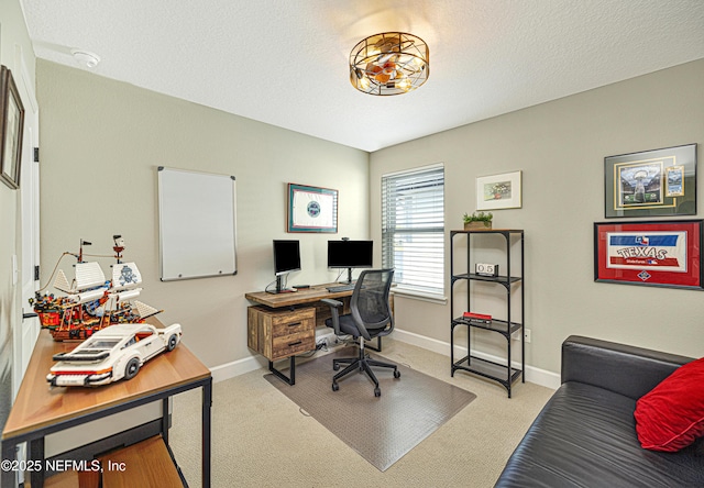 office with carpet floors and a textured ceiling