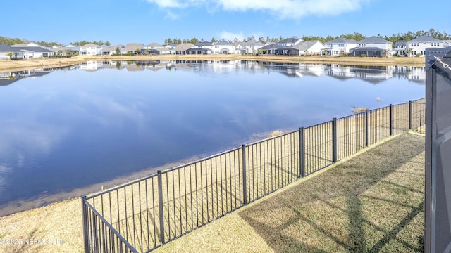 water view with a residential view and fence