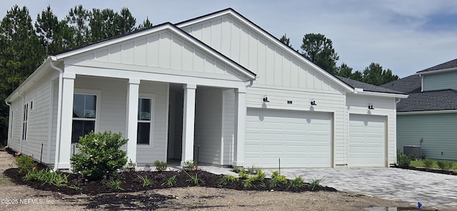255 Sapling Ter, Saint Johns, FL 32259 - view of front of house with board and batten siding, a garage, driveway, and covered porch