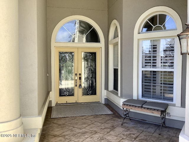 entrance to property with french doors and stucco siding