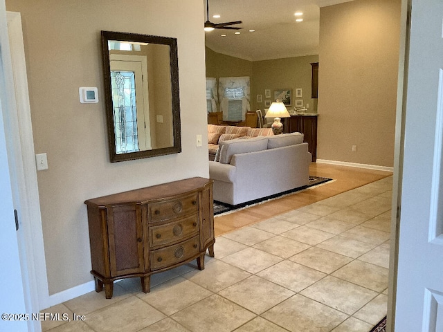 living area with baseboards, a ceiling fan, lofted ceiling, light tile patterned flooring, and recessed lighting