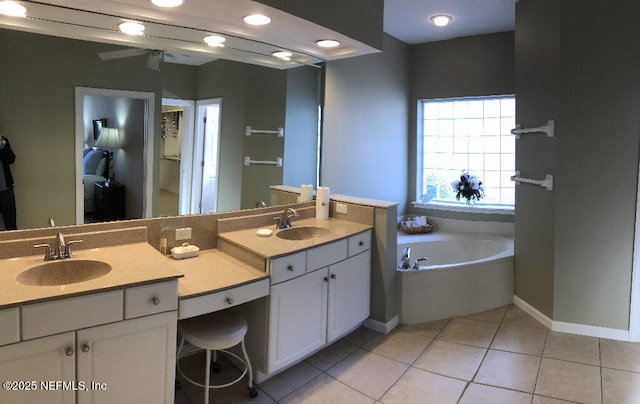 full bath with a garden tub, double vanity, a sink, and tile patterned floors