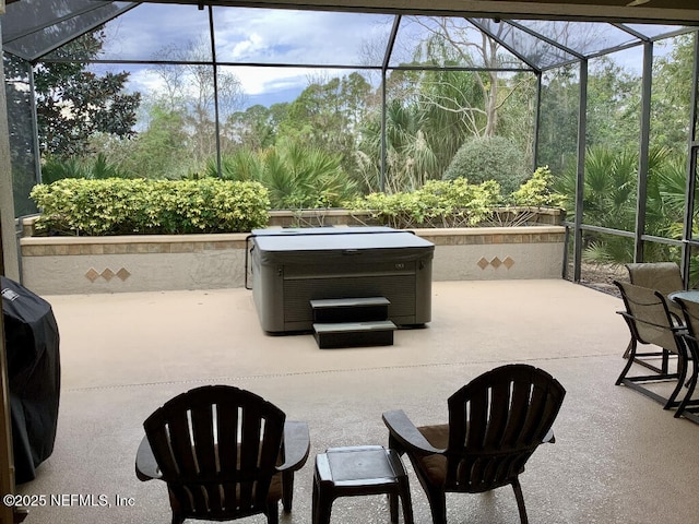 view of patio featuring a lanai and a hot tub